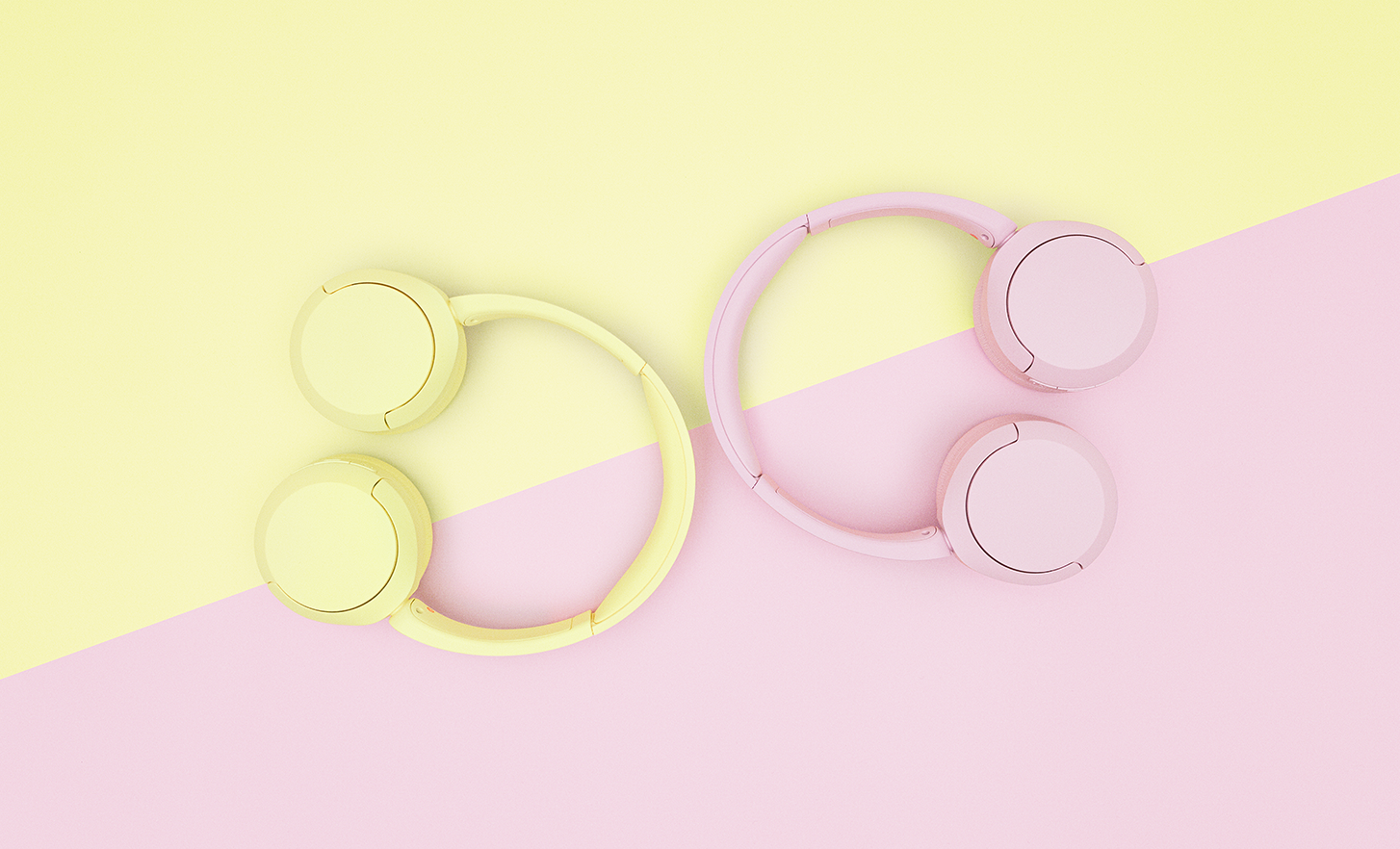 Pairs of pink and yellow Sony WH-CH520 headphones on a pastel two-tone background.