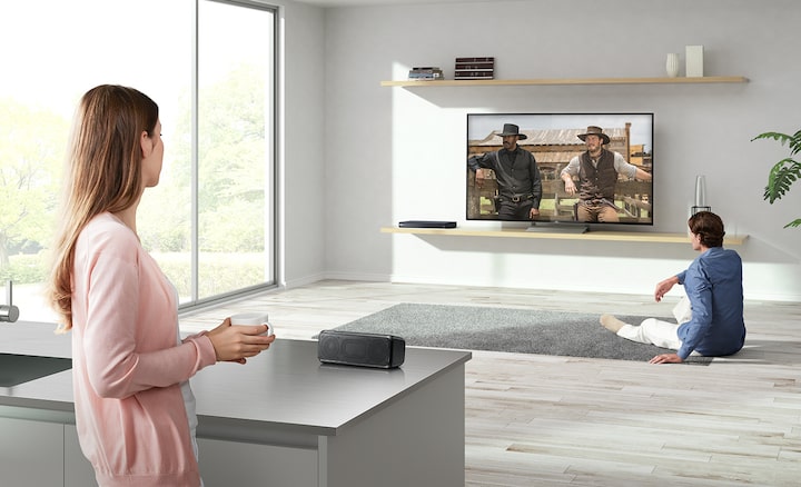 Couple watching a TV, one near, one far way